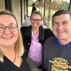 Three guests smiling together on a cellar door verandah in the Hunter Valley