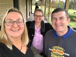 A Hunter Valley Tours guide and two guests smiling together in a cellar door selfie