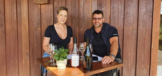 A couple at a tasting table with the day's bottles in front of them