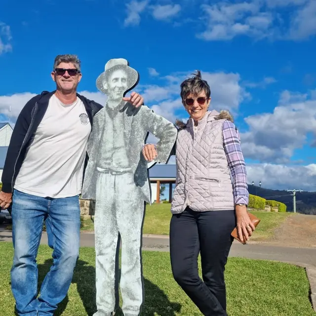 Two guests posing with a life-size vineyard worker cut-out
