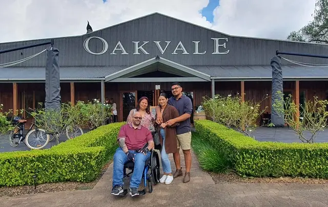 A guest in a wheelchair with friends at the Oakvale cellar door entrance