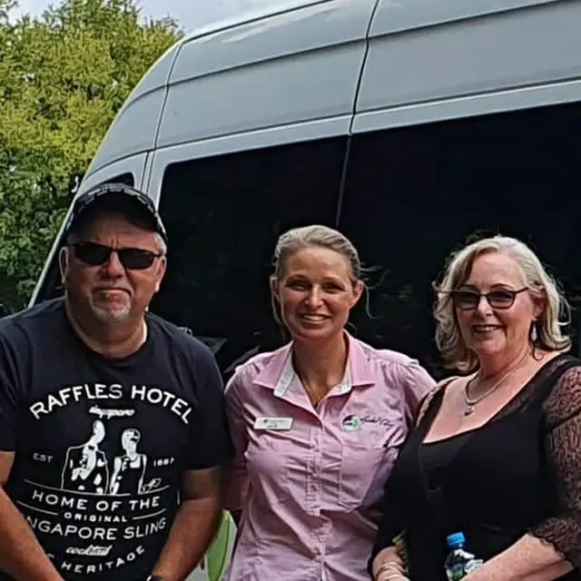 A guide with two guests beside the tour Sprinter