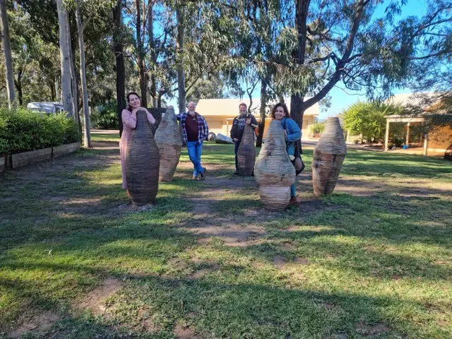 Guests walking among the big ceramic urns on a cellar door lawn