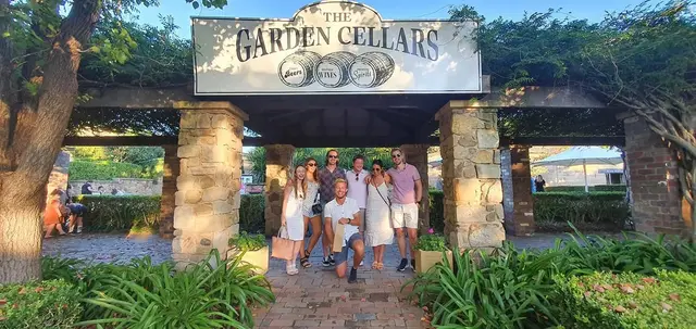 A group under The Garden Cellars entrance arch
