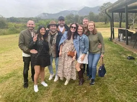 A group of guests on the lawn with the range behind them