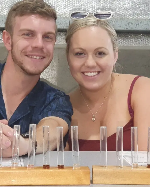 A couple with a tasting flight served in test tubes