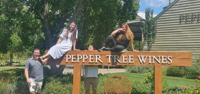 Guests on and around the Pepper Tree Wines sign