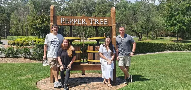 Guests at the Pepper Tree entrance on a bright summer day