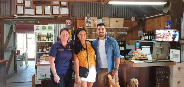 Guests at a cellar door counter with the resident dog