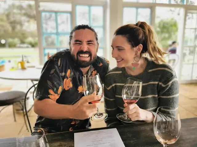 A couple laughing over a tasting in a sunlit room