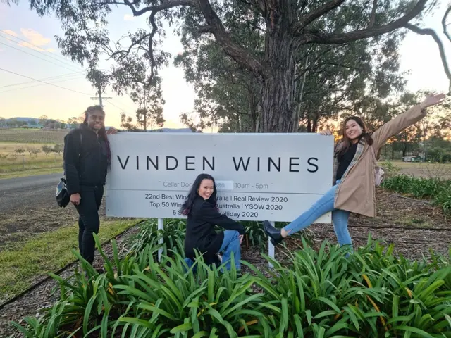 Guests at the Vinden Wines sign as the sun drops