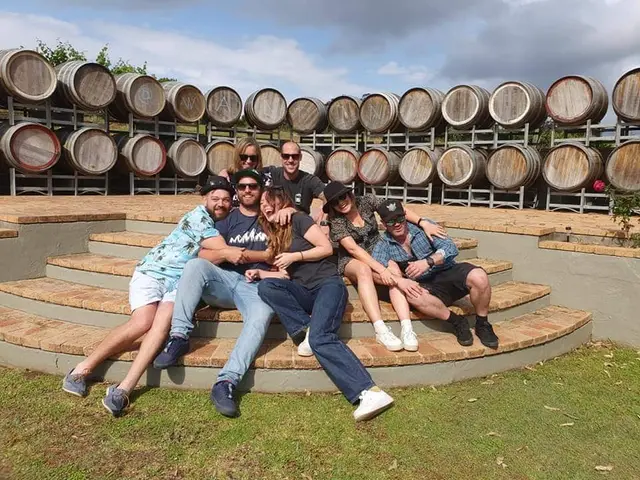 The same group piled on the barrel-room steps for a sillier second photo
