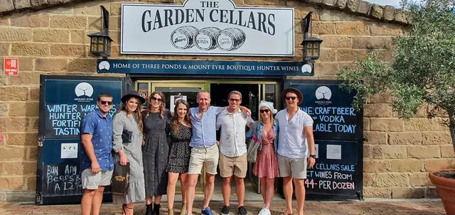 Guests outside The Garden Cellars with the tasting blackboards