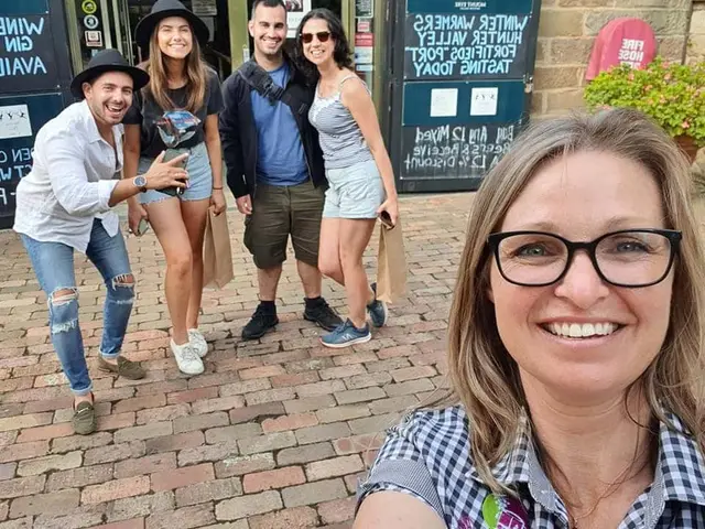 A guide's selfie with guests carrying their cellar door bags