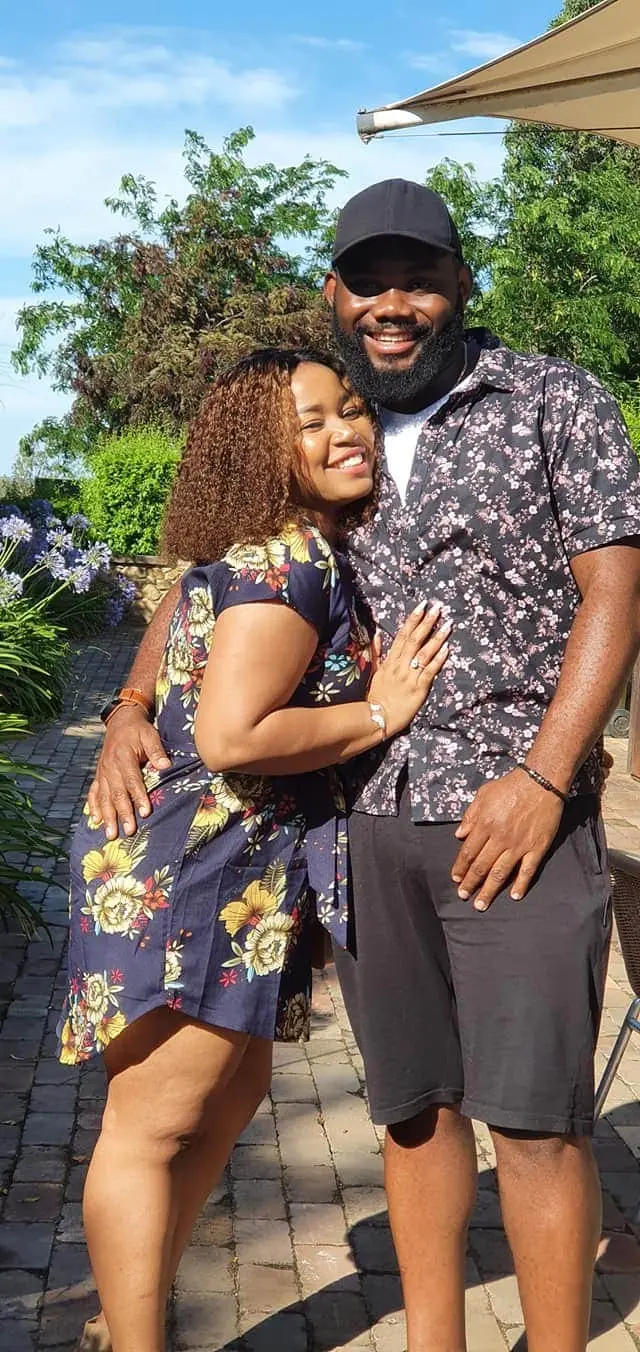 A couple sharing a hug on a cellar door garden path