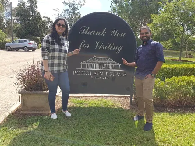 Two guests at a vineyard's thank you for visiting sign