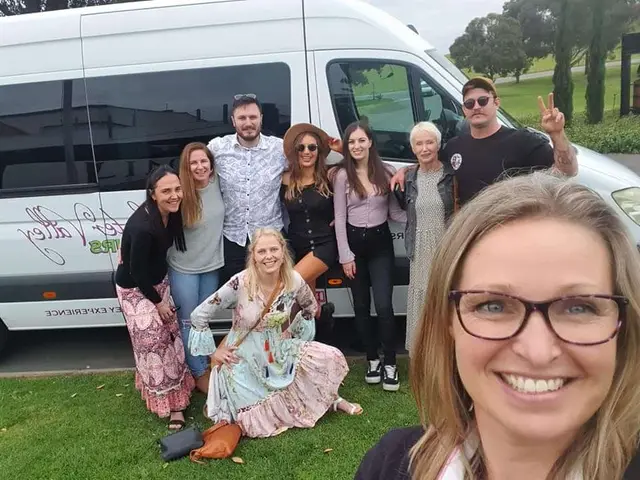 A guide's selfie with the group beside the branded tour bus