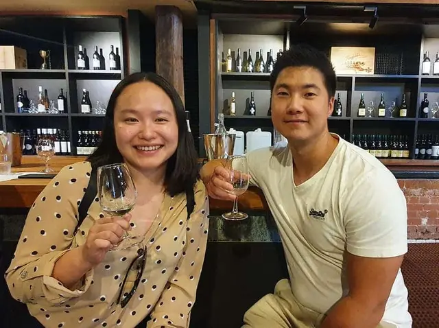 A couple with sparkling wine at a cellar door counter