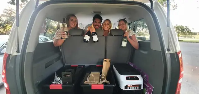 Guests in the back of the van with their sparkling