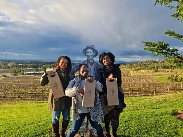 Three guests with their bottles above the vineyard