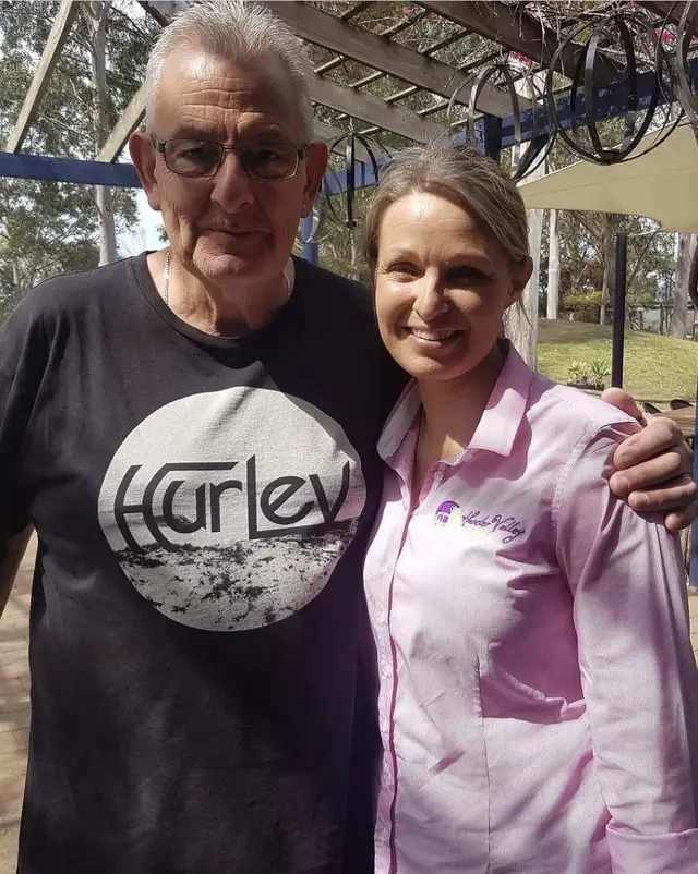A guest with a Hunter Valley Tours guide under the vines
