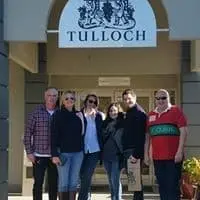 Guests under the Tulloch cellar door sign